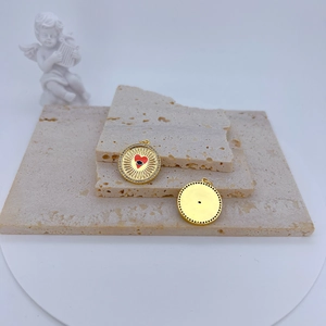Golden geometric evil eye sunburst pendant with red heart and micro-pave zircons