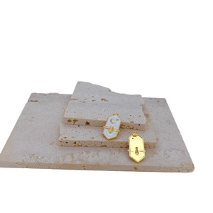 Hexagonal gold bee pendant with white enamel inlay and celestial crescent star patterns