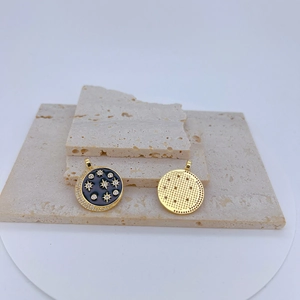 Macro shot of gold-plated celestial pendant with black enamel star inlay and zircon details