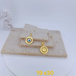 Detailed macro view of gold-plated Evil Eye charms with LOVE engraving and zircons