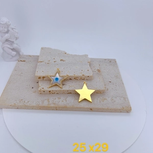 Detailed view of pentagram evil eye charms with blue zircon inlay and gold plating