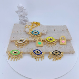 Macro view of colorful Evil Eye charms with micro-pave zircons on a white stone base