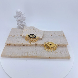 Golden Evil Eye charm with black enamel, zircon inlay, and five leaf tassel pendants