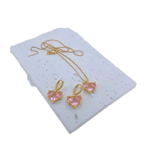 Pink heart-shaped zircon jewelry set including a gold-plated necklace and hoop earrings