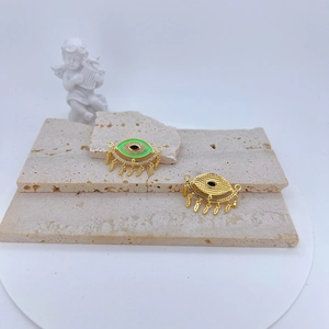 Detail view of colorful evil eye pendants with micro-inlaid zircon on beige stone stand