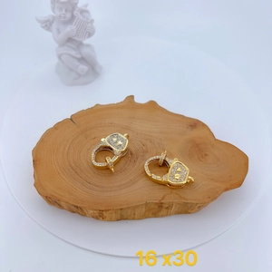 Detail of micro-pave zircon heart lobster clasp in gold finish on wood slice, 16x30mm