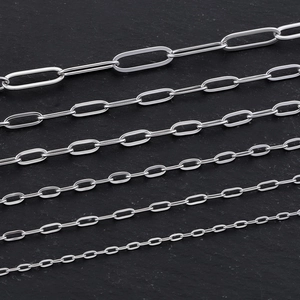 Roestvrijstalen paperclipkettingen in diverse maten gepresenteerd op grijze steen