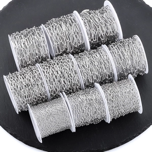 Set of ten stainless steel DIY jewelry chains on white spools for crafting projects