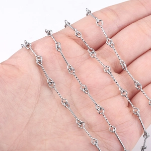 Macro detail of textured stainless steel bar and twist chain necklace for DIY jewelry