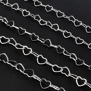 Macro shot of silver stainless steel heart-shaped links for DIY jewelry making