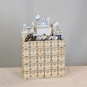Detail showing carved wooden Ramadan advent calendar with thirty drawers and LED lights