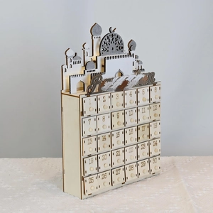 Close-up of wooden Ramadan advent calendar with 30 small drawers and mosque silhouette