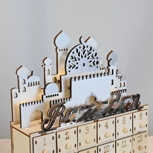 Close-up of wooden Ramadan advent calendar with LED lights and mosque silhouette