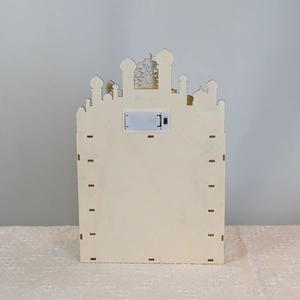 Rear view of wooden castle calendar showing the battery compartment and LED light switch