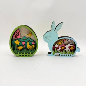 Close-up of laser-cut multi-layer wooden Easter egg and rabbit desktop decorations