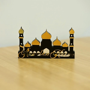 Detail of Ramadan Kareem desk decor with black and gold mosque silhouette and acrylic text