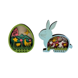 Detail of multi-layered wooden Easter eggs with colorful spring rabbit and chick scenes