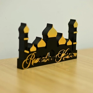 Detail view of black acrylic Ramadan Kareem mosque silhouette with golden calligraphy art