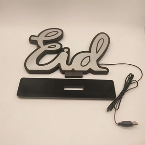 Detail view of acrylic Eid LED tunnel lamp with black base and USB power cable connector