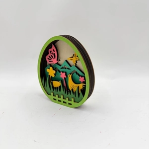 Detail of 3D layered wooden Easter egg showing intricate laser-cut pastoral scenery