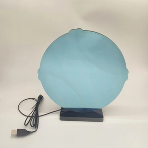 Close-up of circular acrylic night light with black base and USB power cable for DIY decor