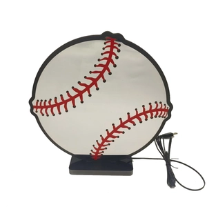 Detailed view of baseball LED night light with red stitching and USB power base