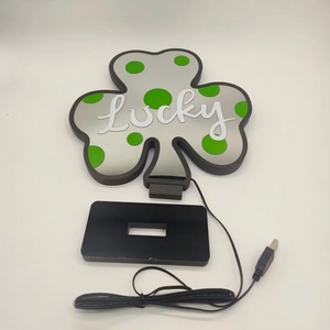 Detail of clover neon sign with Lucky text, black base and USB cable for Saint Patrick Day