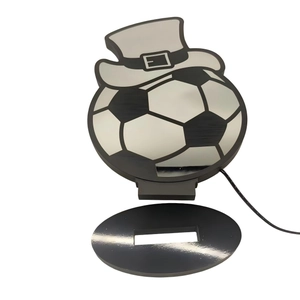 Creative soccer ball desk lamp with a top hat design on a sleek black oval power base