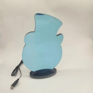Close-up of snowman acrylic night light with USB cable and black base stand