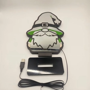 Detail of St. Patrick's Day LED gnome light with green clover and USB mirror finish