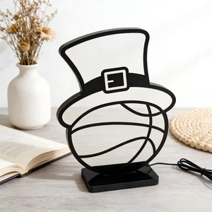 Creative St. Patrick's Day basketball hat LED night light on a cozy wooden desk setup