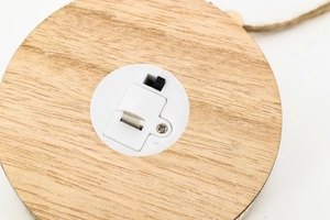 Detail of wooden base with LED battery compartment and power switch for hanging cabin