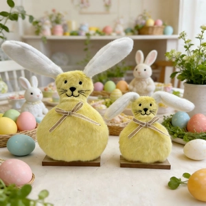 Detail of yellow plush Easter bunnies with jute bows on wooden base for festive decor