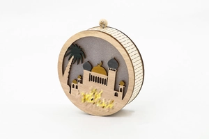 Detail of multi-layer 3D wooden mosque ornament with golden dome and hanging beads