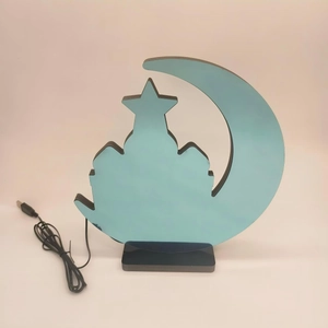 Detail of blue LED crescent moon tunnel light with mosque silhouette and USB cable