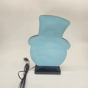 Detail of a snowman-shaped acrylic night light with a USB cable and rectangular base