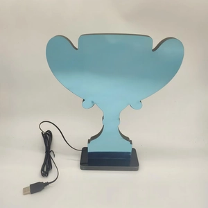 Detail of blue LED jersey trophy lamp with black base and USB power cable for decor