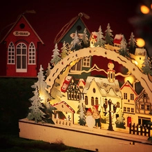 Detail of wooden Christmas bridge lamp with laser-cut village scene and warm LED light