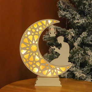 Detail of wooden crescent moon LED lamp with intricate laser-cut star patterns