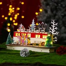 Detail of a lighted Christmas camper bus featuring Santa and gnomes on a wooden base