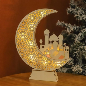 Detail of wooden crescent moon LED lamp with mosque silhouette and Eid Mubarak text