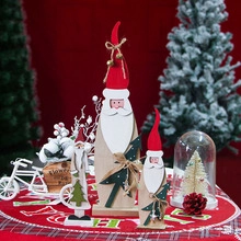 Detailed view of three tiered wooden Christmas gnomes with red hats and gold bells