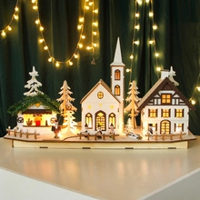 Macro view of wooden Christmas village ornament with warm LED lighting and snowy details
