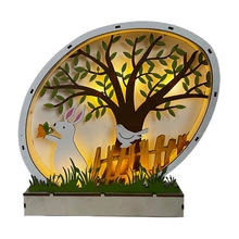 Detail of multi-layered wooden Easter egg lamp with rabbit silhouette and warm LED light