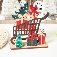 Detail of wooden Christmas cart with mini tree and gift boxes on a rustic base