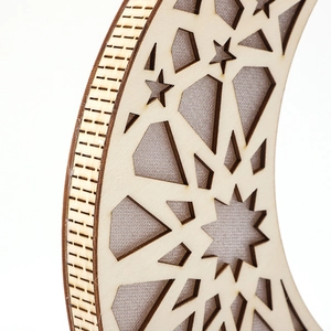 Detailed view of laser-cut wooden crescent moon with intricate geometric patterns