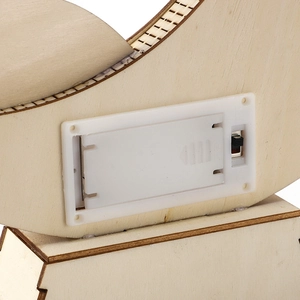 Close-up of the wooden moon ornament's battery compartment and power switch details