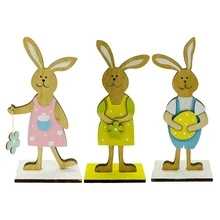 Drei farbenfrohe Osterhasen-Holzfiguren mit Blumenmustern und Osterei in Nahaufnahme