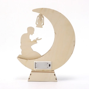Detail view of the wooden crescent moon lamp with praying silhouette and battery box