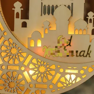 Detail of wooden Eid Mubarak moon lamp with laser cut patterns and warm LED light